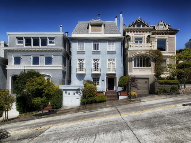 an outside view of a blue house in San Francisco that can be rented for travel nurse housing 