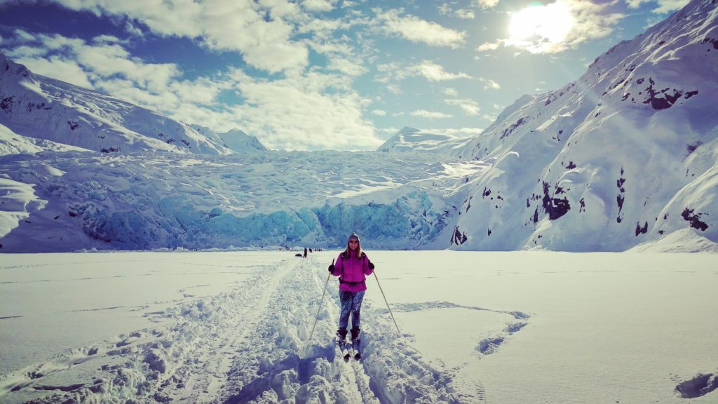 female cross country skiing in Alaska with a view of the mountains